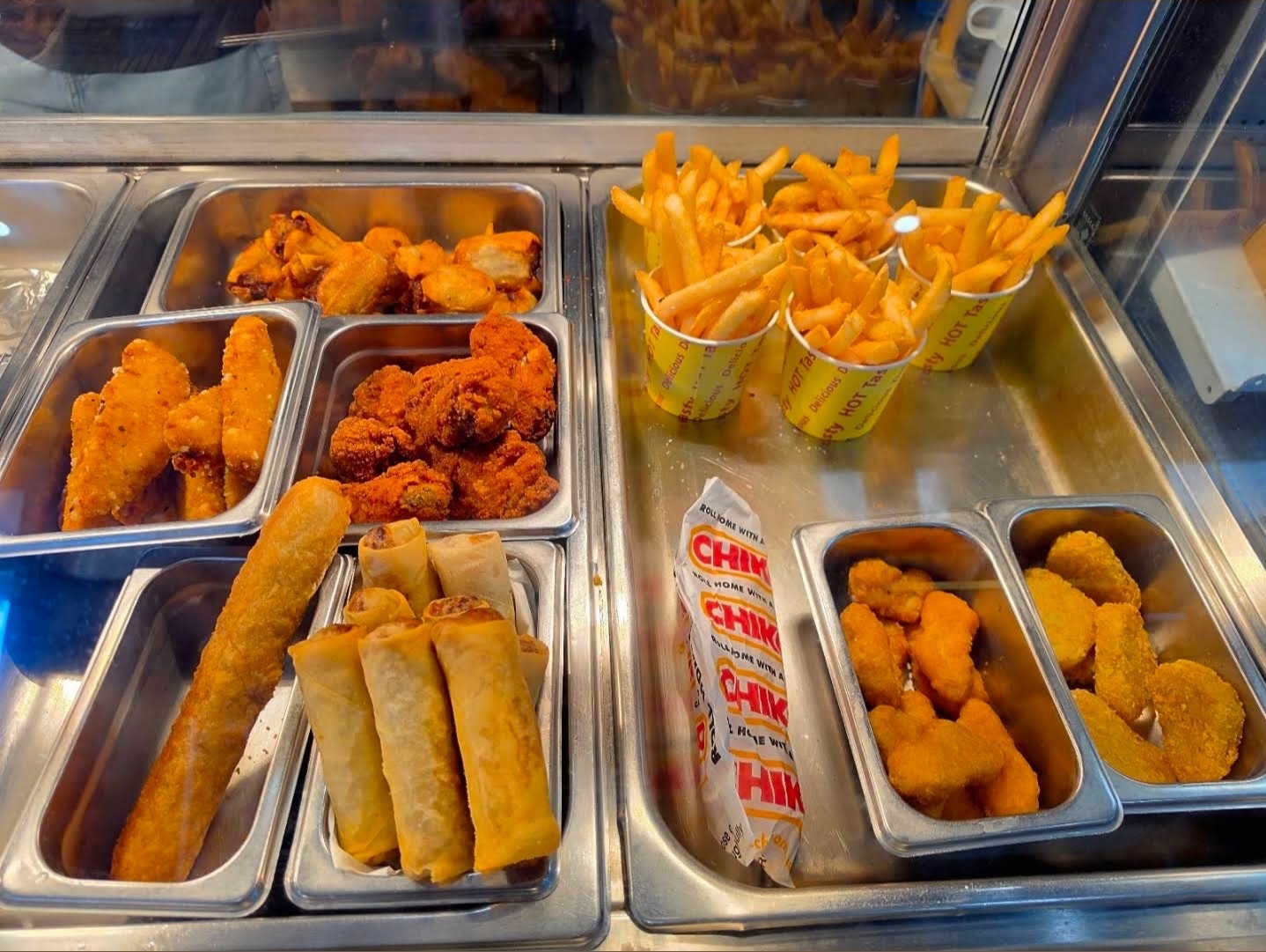 Hot food cabinet with chips, chicken tenders, spring rolls and nuggets